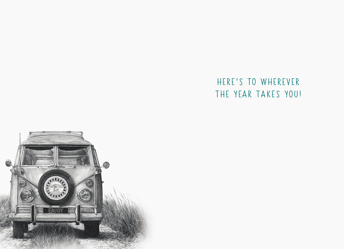Interior of an adventure-themed birthday card, showing a subtle illustration of a vintage camper van in the bottom left corner. The uplifting message reads: 'HERE'S TO WHEREVER THE YEAR TAKES YOU!'. Perfect for conveying inspiring wishes.