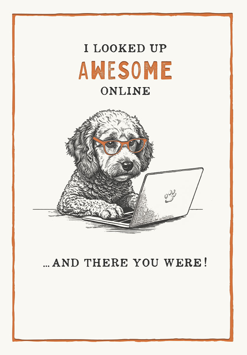 Front of a funny birthday greeting card featuring a doodle dog wearing orange glasses, sitting at a laptop with the text 'I looked up AWESOME online... AND THERE YOU WERE!'. Perfect for dog lovers.