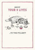 Funny greeting card front featuring a content tabby cat sound asleep amidst eaten cupcake wrappers and untouched cupcakes, with text 'ENJOY YOUR 9 LIVES ...TO THE FULLEST!' in a pink border, perfect for cat lovers.