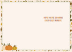 Inside view of a cozy autumn greeting card with the message 'HOPE YOU'RE SAVORING EVERY COZY MOMENT.' printed in orange and purple, framed by an elegant border of green leaves, yellow foliage, and small pumpkins.