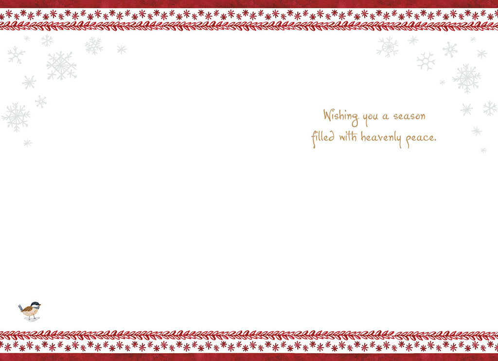 Inside of a religious greeting card with a serene message 'Wishing you a season filled with heavenly peace', adorned with delicate snowflake corners and red berry garland borders.