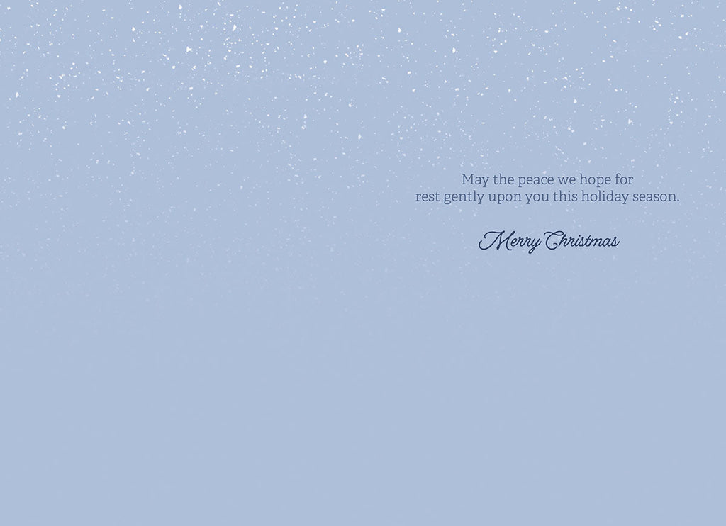 Interior of a holiday greeting card with a light blue background and a heartfelt message wishing peace for the recipient during the season.