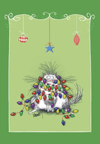 Funny white fluffy cat tangled in a string of colorful Christmas lights, looking surprised, against a festive green background. Humorous holiday greeting card front.