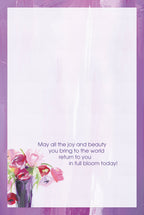Inside of a heartfelt floral greeting card with a light purple wash background, small bouquet accent, and the message 'May all the joy and beauty you bring to the world return to you in full bloom today!'