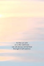 Soft, ethereal sky with a gentle sunrise glow and the touching quote 'As the sun sets on a life well lived, we will always remember the light it left behind.', ideal for a condolence card.