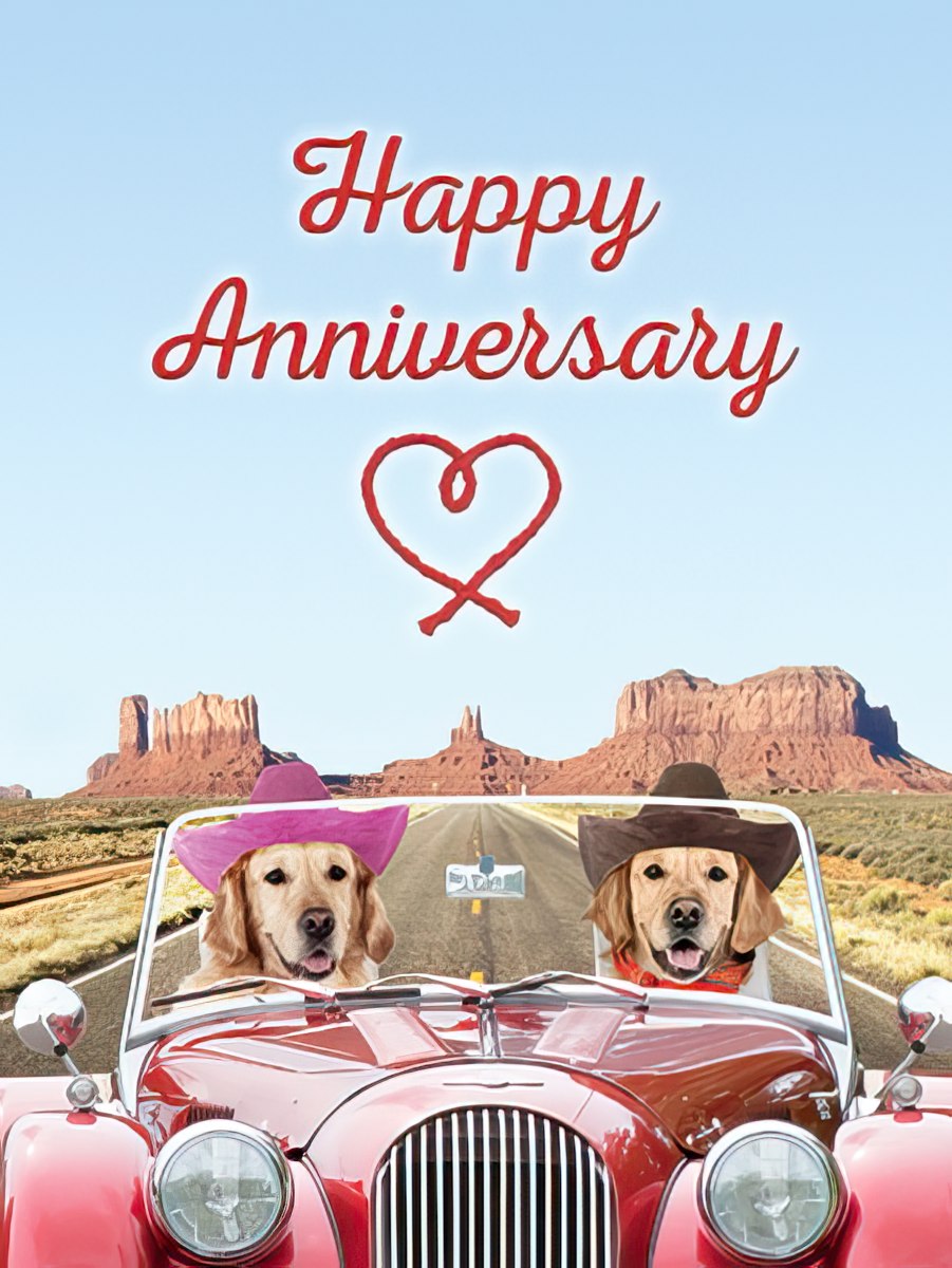 Happy Anniversary card with two golden retrievers in cowboy hats driving a red classic car through a desert landscape with mountains.