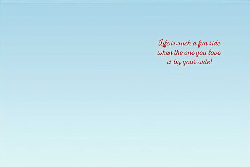Inside of a romantic anniversary greeting card with the heartfelt message: 'Life is such a fun ride when the one you love is by your side!' on a light blue background.