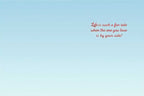 Inside of a romantic anniversary greeting card with the heartfelt message: 'Life is such a fun ride when the one you love is by your side!' on a light blue background.