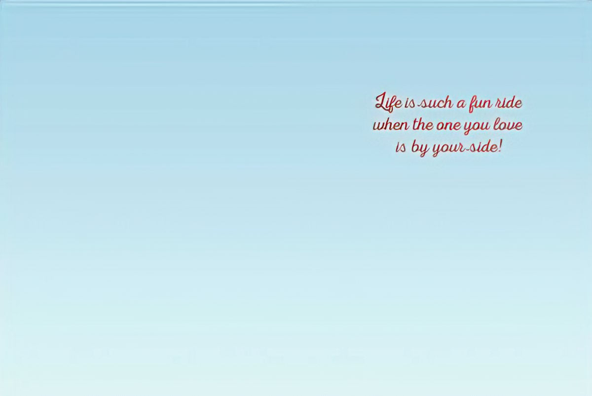 Inside of a romantic anniversary greeting card with the heartfelt message: 'Life is such a fun ride when the one you love is by your side!' on a light blue background.