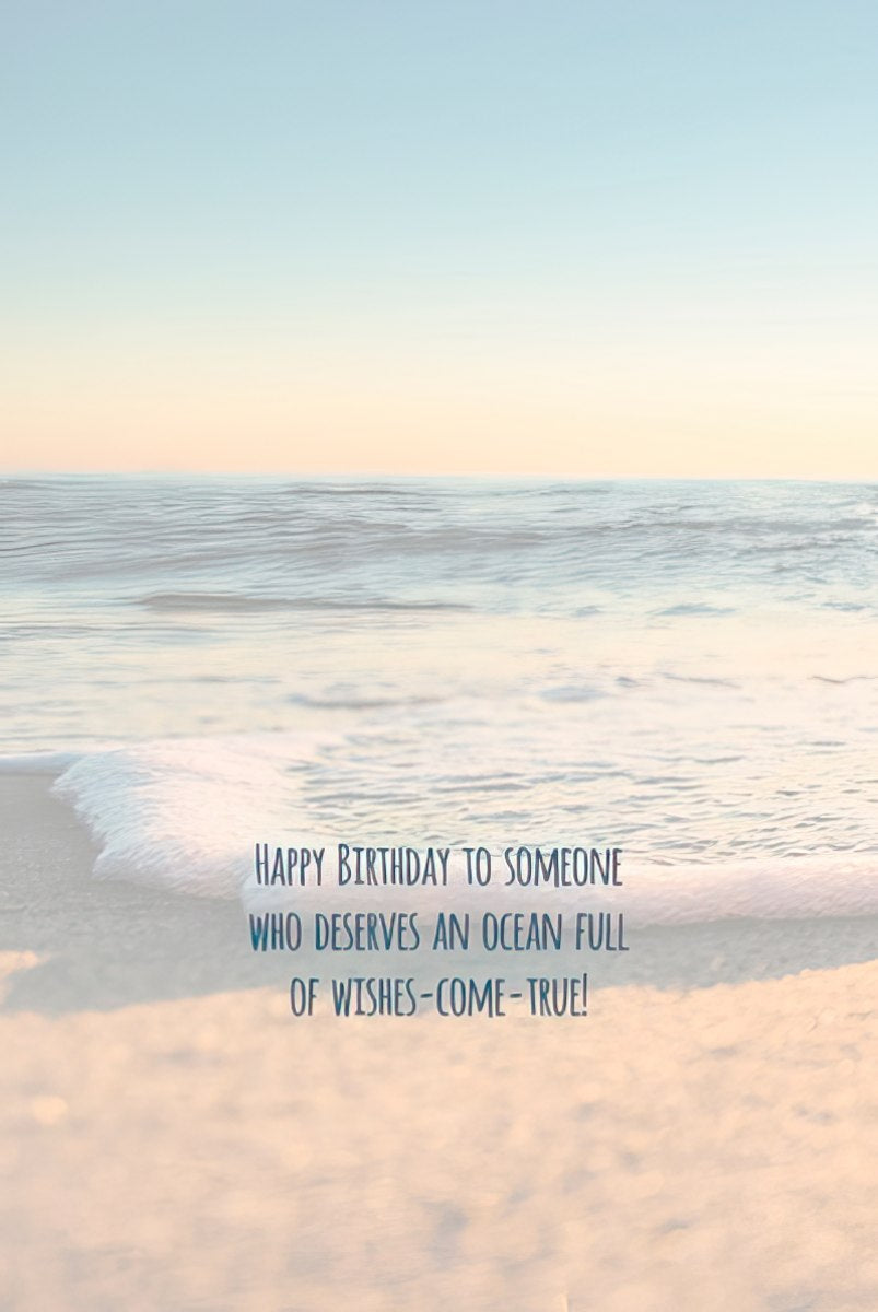 Inside of a greeting card with a serene beach and ocean view, text reads 'HAPPY BIRTHDAY TO SOMEONE WHO DESERVES AN OCEAN FULL OF WISHES-COME-TRUE!'