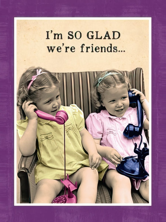 Two smiling young girls talking on vintage pink and black rotary phones. Front of a funny friendship greeting card.
