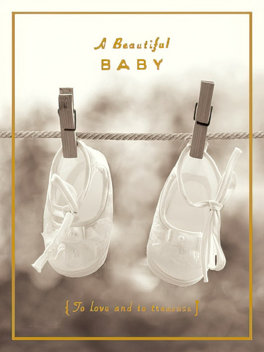 Sepia-toned greeting card front with white baby shoes hanging on a clothesline, text 'A Beautiful BABY {To love and to treasure}'.