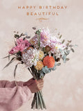 Elegant floral greeting card for her, featuring a beautiful bouquet of pink, white, and orange dahlias held by a hand, with 'HAPPY BIRTHDAY BEAUTIFUL' in gold lettering. Perfect romantic birthday card for wife, girlfriend, or partner.