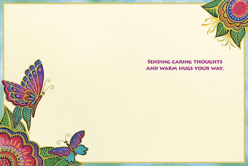 Inside of a supportive greeting card showing corner designs of colorful butterflies and floral patterns with text 'SENDING CARING THOUGHTS AND WARM HUGS YOUR WAY' on a cream background.