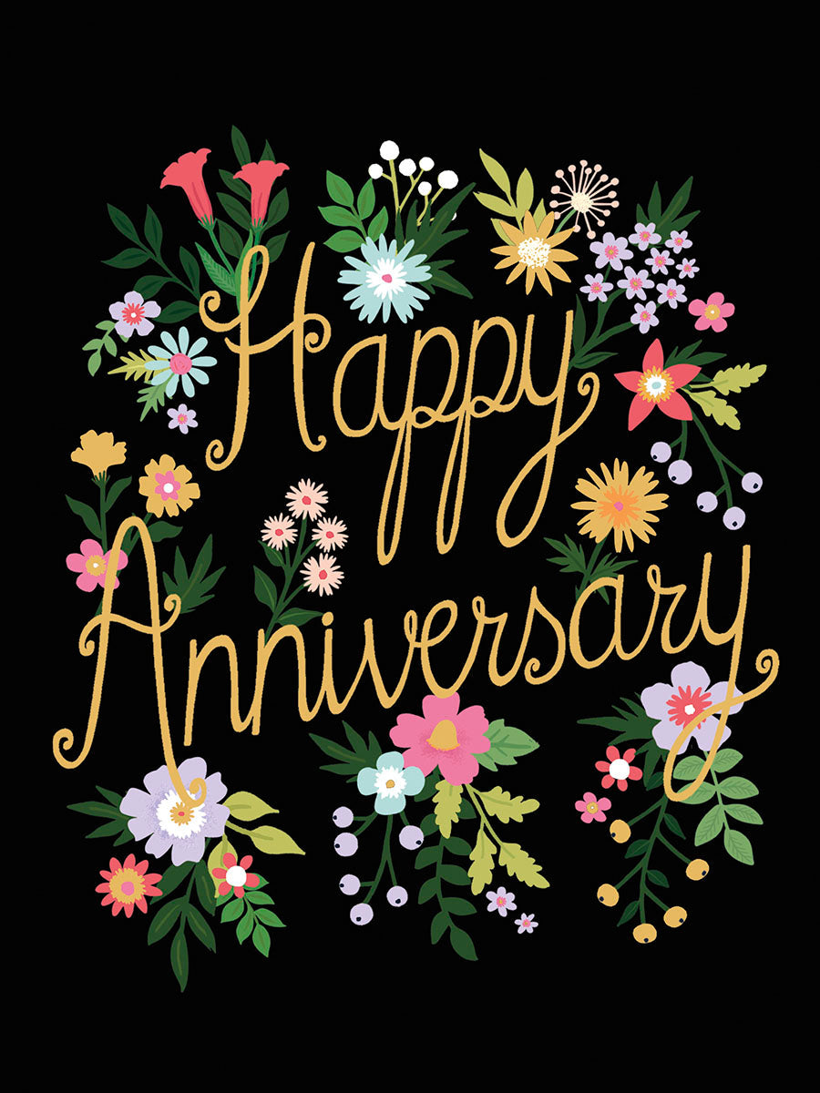 Front of floral Happy Anniversary card on black background, featuring a vibrant wreath of colorful flowers and elegant gold script.