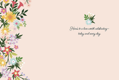 Inside of an anniversary card with a soft pink background, a delicate floral border, and the heartfelt message about lasting love.