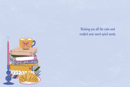 Inside of a cozy encouragement greeting card with an illustration of books, teacup, and croissant, and a comforting message.