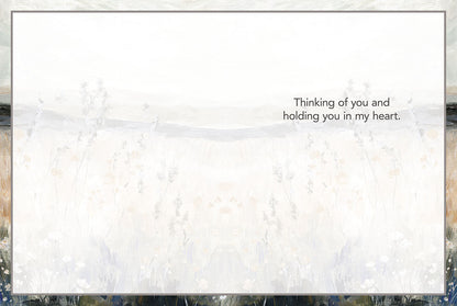 Inside of a sympathy card with matching painterly landscape background, text reads 'Thinking of you and holding you in my heart.'.