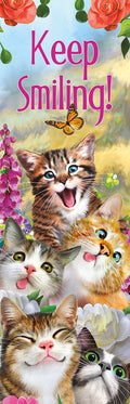 Keep Smiling! bookmark featuring a stack of four joyful cartoon cats with bright eyes and playful expressions, surrounded by vibrant pink and purple flowers and a monarch butterfly, against a cheerful sky background. Ideal for cat lovers and bookworms.