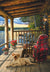 Dog on porch of lakeside cabin