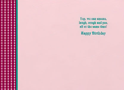 Inside of a Maggie Mae card with pink background and text 'Yep, we can sneeze, laugh, cough and pee, all at the same time! Happy Birthday'.