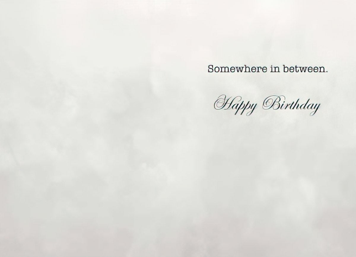 Inside of a Maggie Mae card with cloud-like background and text 'Somewhere in between. Happy Birthday'.