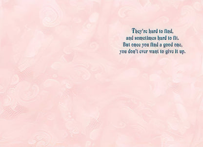 Inside of a Maggie Mae card with pink swirl background and text 'They're hard to find, and sometimes hard to fit. But once you find a good one, you don't ever want to give it up.'.