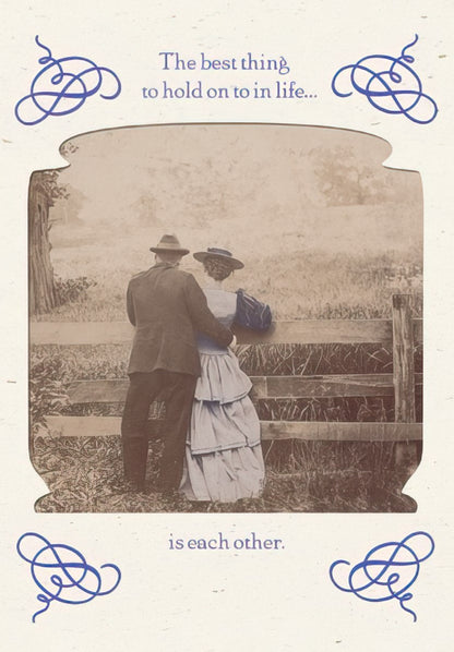 Maggie Mae card with vintage photo of a couple standing by a fence, text 'The best thing to hold on to in life...'.
