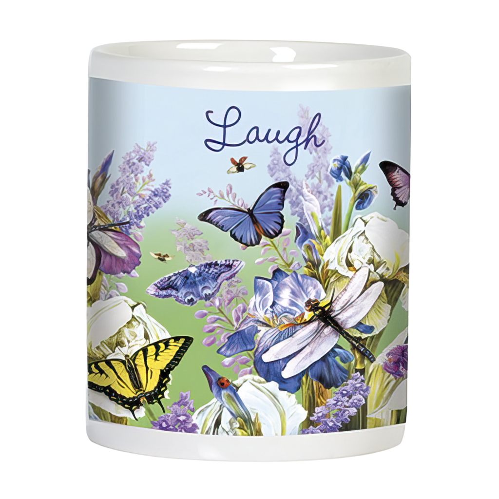 Side view of a white ceramic mug with 'Laugh' written on it, decorated with blue butterflies, dragonflies, and blooming purple and white iris flowers against a light blue and green background.