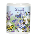 Side view of a white ceramic mug with 'Laugh' written on it, decorated with blue butterflies, dragonflies, and blooming purple and white iris flowers against a light blue and green background.