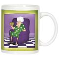 Front view of a white ceramic mug featuring a cartoon illustration of a sassy elderly woman with white hair and glasses, wearing a green floral dress, relaxing in a purple armchair with a patterned green cup in hand. The background depicts a purple wall and a black and white checkered floor, bordered by a vibrant green band around the mug. Perfect for a funny grandparent gift.