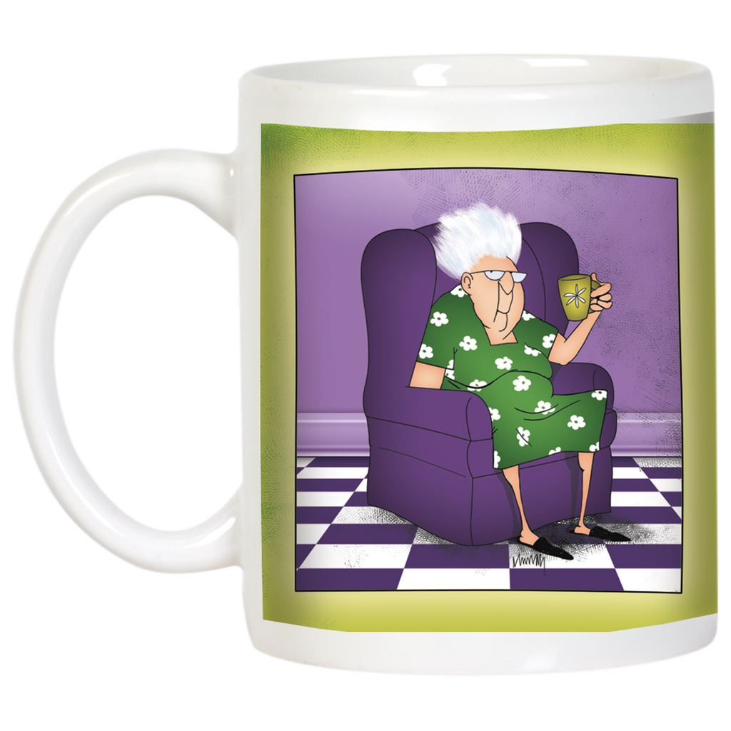 Angled view of the white ceramic mug, highlighting the cartoon of a sassy elderly woman in a purple armchair holding a cup. The mug has a prominent white handle and the character is set against a purple backdrop with a checkered floor, with a green border. This humorous mug is a great gift for her.