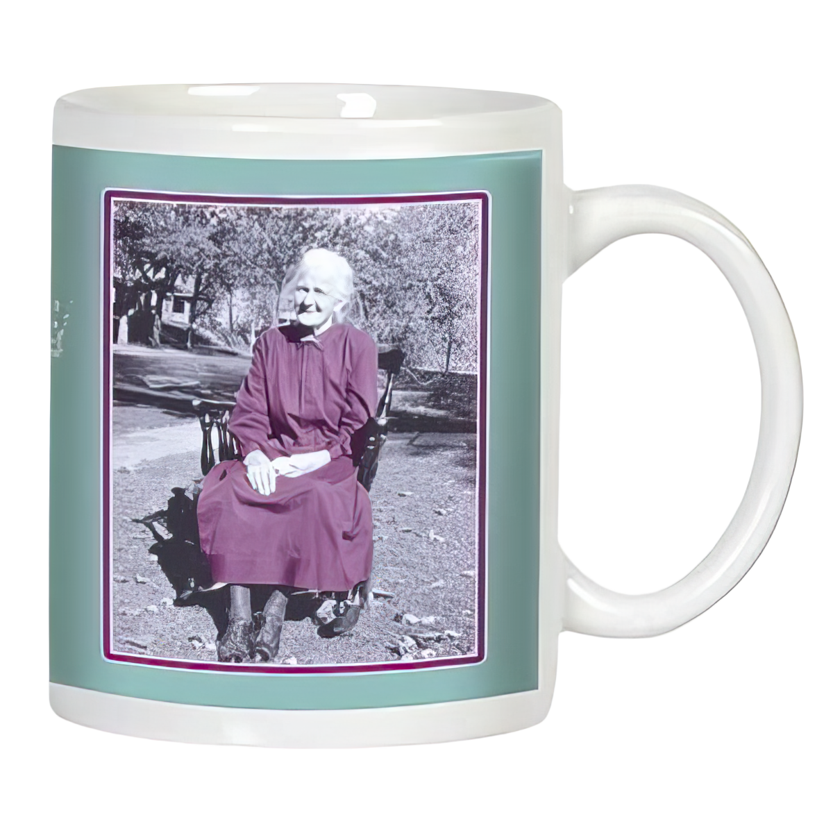 White ceramic mug featuring a vintage-style black and white photo of a smiling elderly woman in a dress sitting outdoors, framed by a teal border.