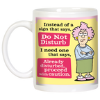Frontal view of the humorous 'Already Disturbed' mug, highlighting the detailed illustration of the fed-up woman and the bold, witty text on a vibrant yellow and pink design, with the mug handle visible.