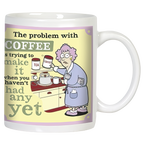 Front view of a funny white ceramic coffee mug featuring a confused woman in a robe struggling to make coffee before her first sip, with the humorous text 'The problem with COFFEE is trying to make it when you haven't had any yet.' Perfect for coffee lovers.