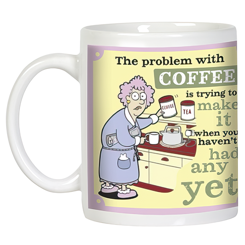 Angled view of a humorous coffee mug displaying a cartoon character attempting to brew coffee with difficulty, illustrating the relatable struggle of 'The problem with COFFEE' before caffeine kicks in. Ideal gift mug.