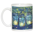 Another front view of the white ceramic 'Be a Light to the World' mug, highlighting the detailed illustration of three mason jar lanterns with glowing candles amidst foliage.