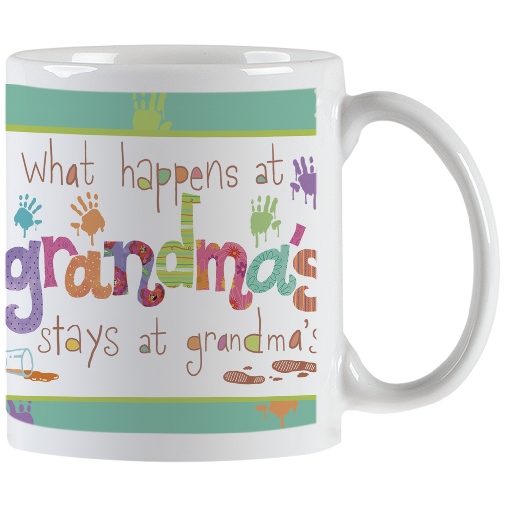 White ceramic mug with 'What happens at grandma's stays at grandma's' text in colorful, playful fonts with paint splatters and handprints, perfect funny gift for grandmothers.