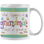 White ceramic mug with 'What happens at grandma's stays at grandma's' text in colorful, playful fonts with paint splatters and handprints, perfect funny gift for grandmothers.
