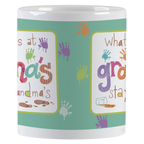Close-up side view of a white ceramic mug, showing colorful 'grandma's stays at grandma's' text with various colored handprints and paint drops, ideal for a grandparent's humorous coffee cup.