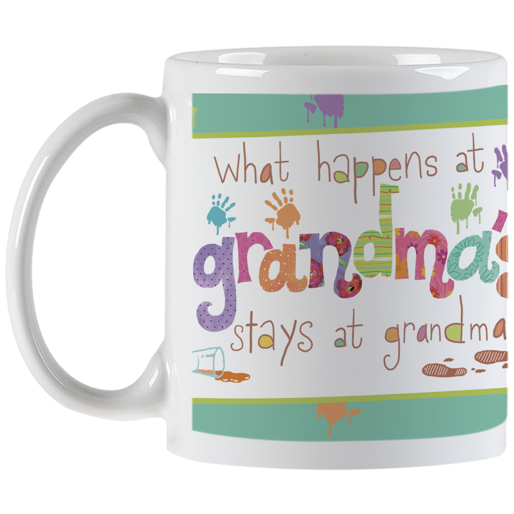 Angled view of a white ceramic handle mug featuring the full colorful 'What happens at grandma's stays at grandma's' quote, surrounded by playful handprints and paint splatters, a unique gift for grandmas.