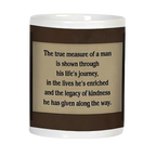 Back of an inspirational white coffee mug with the quote 'The true measure of a man is shown through his life's journey, in the lives he's enriched and the legacy of kindness he has given along the way,' on a light brown background.