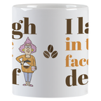 Side view of the 'I laugh in the face of decaf' white coffee mug, highlighting the cartoon character with a coffee pot, coffee bean graphics, and parts of the humorous text.