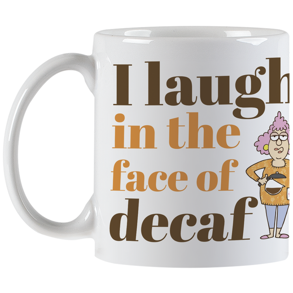 Front view of the white coffee mug displaying the complete 'I laugh in the face of decaf' phrase and the expressive cartoon woman, showcasing the mug's design and handle.