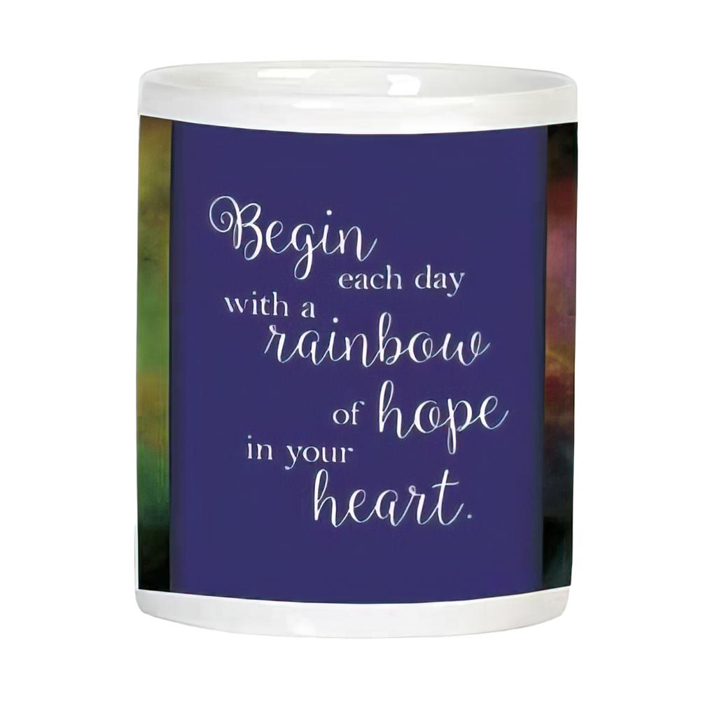 Side view of white ceramic mug displaying an inspirational quote 'Begin each day with a rainbow of hope in your heart' on a deep purple background.