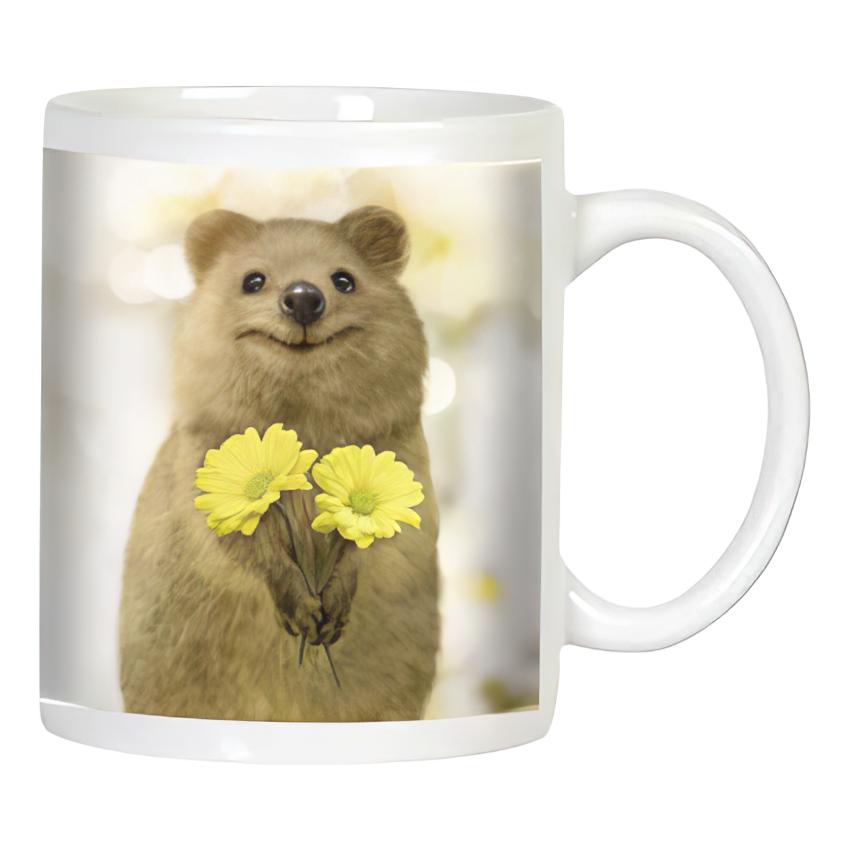 White ceramic coffee mug featuring a smiling quokka holding two cheerful yellow daisy-like flowers on a bright, blurry background.