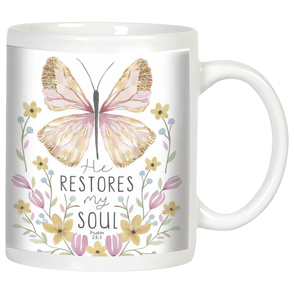White ceramic coffee mug with watercolor butterfly and floral design. Features inspirational quote 'He RESTORES my SOUL Psalm 23:3' in elegant typography, perfect for spiritual comfort.