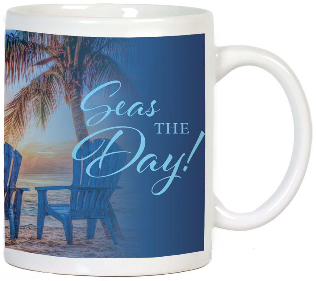 White ceramic coffee mug with 'Seas THE Day!' in elegant light blue script. The mug features a serene beach sunset scene, a palm tree, and two blue Adirondack chairs. Ideal for daily inspiration and beach lovers.