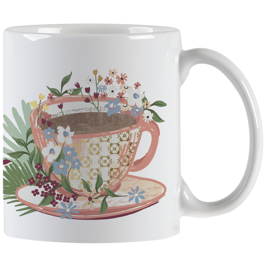 White ceramic mug featuring an elegant floral teacup design overflowing with colorful blossoms, perfect for morning coffee or tea.