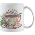 White ceramic mug featuring an elegant floral teacup design overflowing with colorful blossoms, perfect for morning coffee or tea.